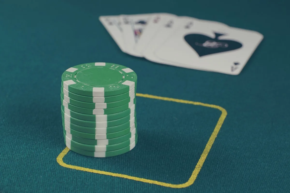 Stacked poker chips on a green casino table